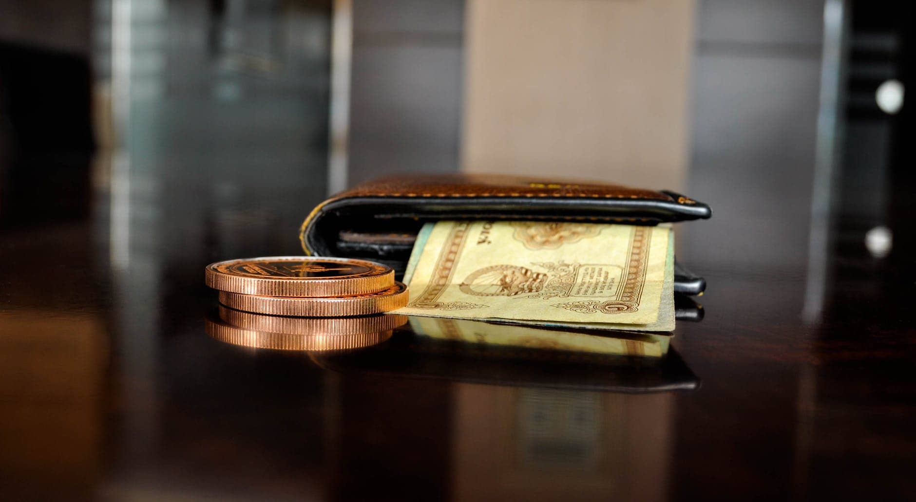 brown leather bifold wallet with banknotes sticking out
